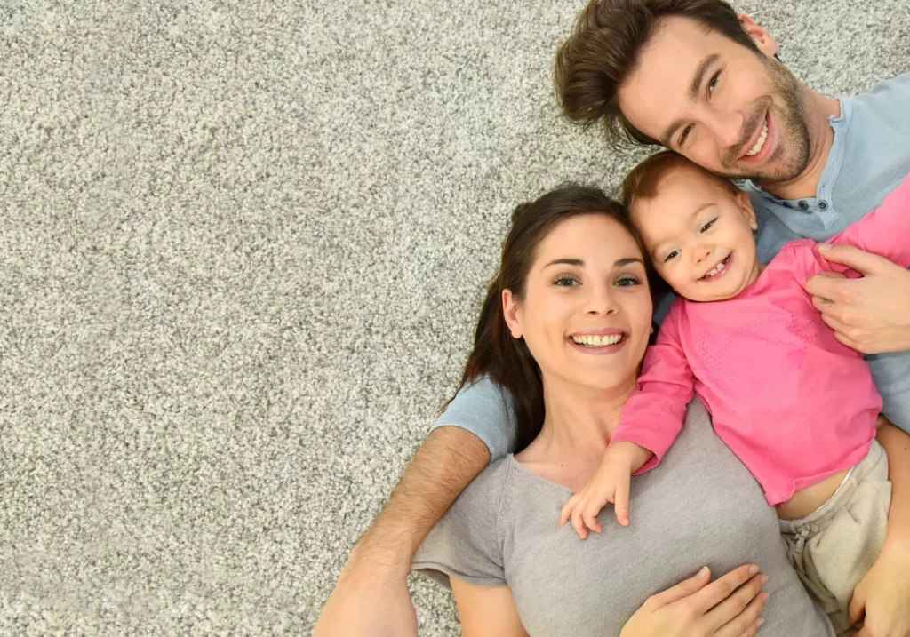 Happy family laying on floor | Roger's Flooring